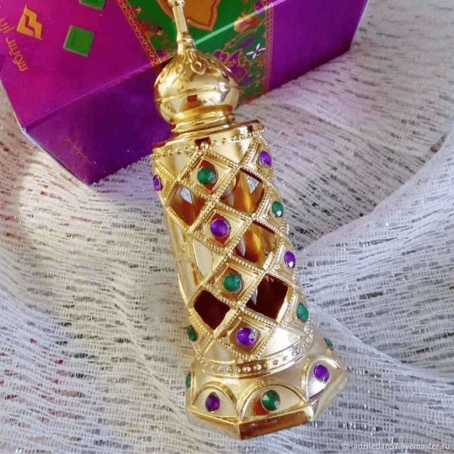 Swiss Arabian Al Ayam perfume oil bottle, 15ml CPO concentrated perfume oil, elegant glass container with gold accents.