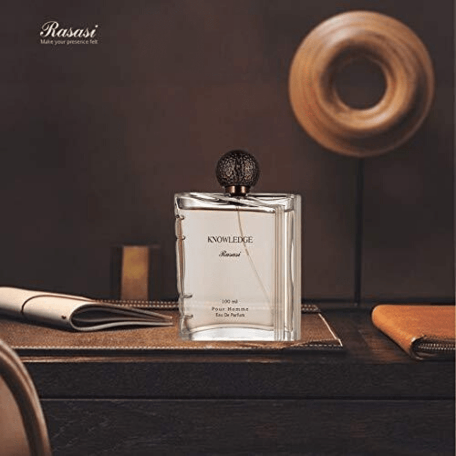 Rasasi Knowledge for Men EDP 100ML bottle with velvet pouch, featuring sleek glass design and silver cap.