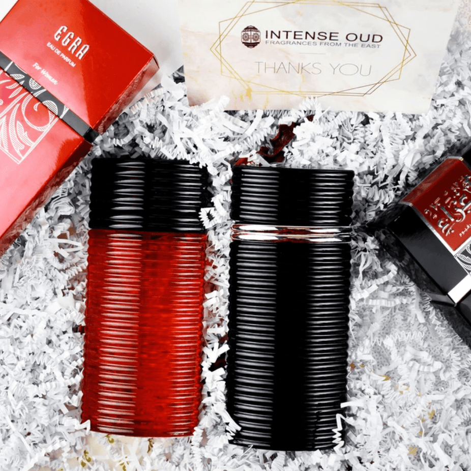 Rasasi Egra EDP couple set with 100ml bottles for men and women, featuring elegant packaging and fragrance bottles.