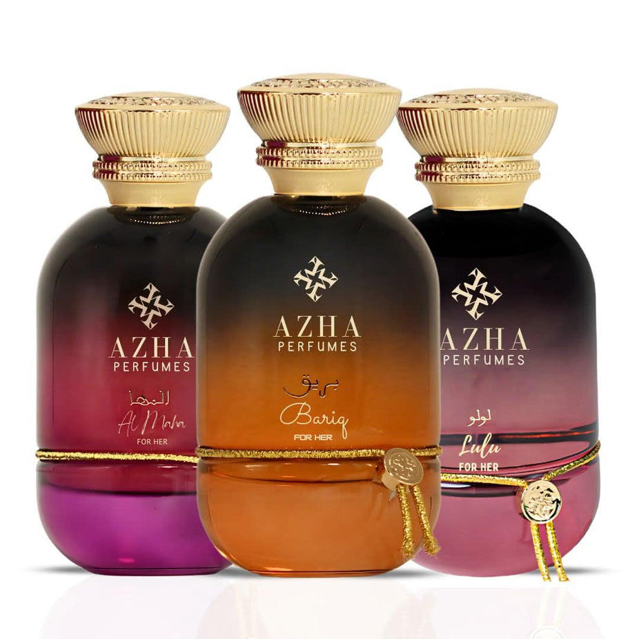 Azha Bariq, Lulu & Al Maha For Her Eau De Parfum collection with three 100ml spray bottles, elegant packaging, and floral accents.