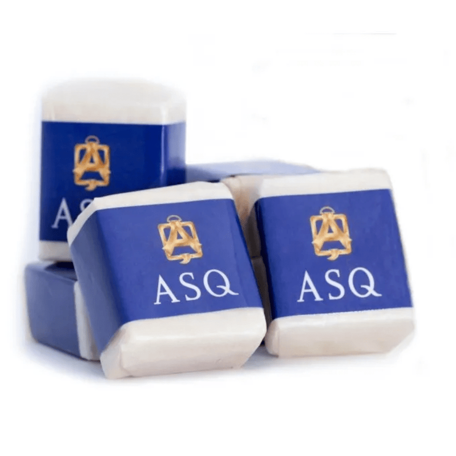 Six solid musk cubes by Abdul Samad Al Qurashi in a clear container, showcasing the aromatic musk scent and traditional packaging.