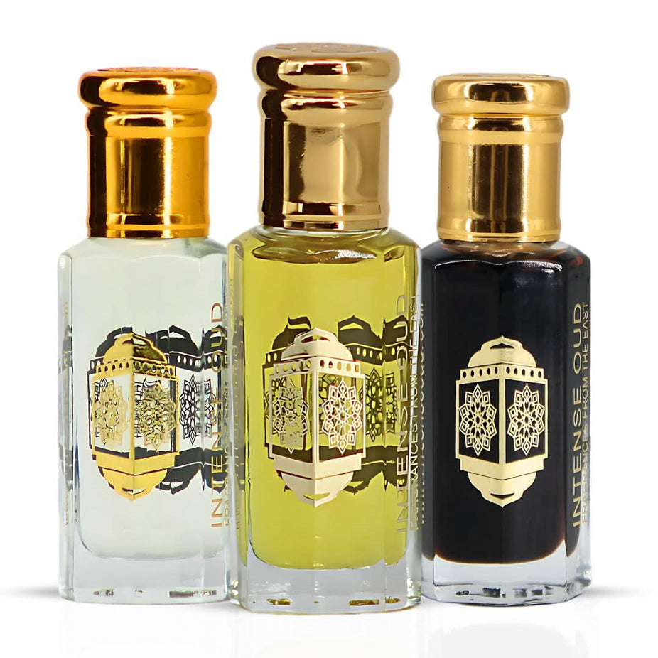 Intense Oud Noble Fruits Bloom & Aphrodisiac perfume oils bundle in black gift box, 12ml, with colorful floral and fruit illustrations.