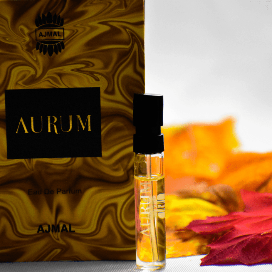 A 1ml Ajmal Aurum EDP sample bottle for women, featuring elegant packaging and a clear view of the perfume sample.