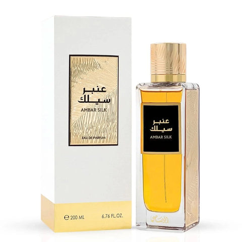 Rasasi Ambar Silk Eau de Parfum spray and Gold Saffron perfume oil duo featuring warm spice and elegant fragrances.