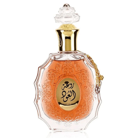Lattafa Rouat Al Oud Eau De Parfum spray 100ml with velvet pouch, showcasing the elegant perfume bottle and packaging.