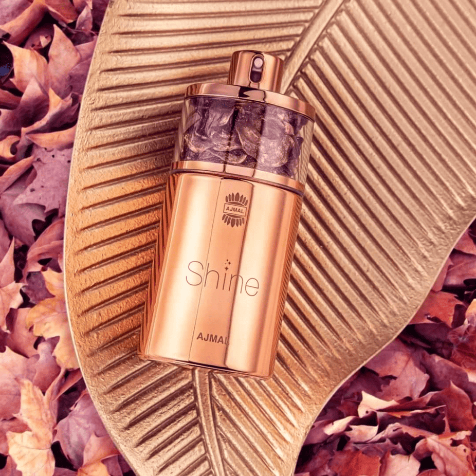 Ajmal Shine for Women Eau De Parfum 75ml bottle with elegant packaging and floral design, showcasing a luxurious fragrance.