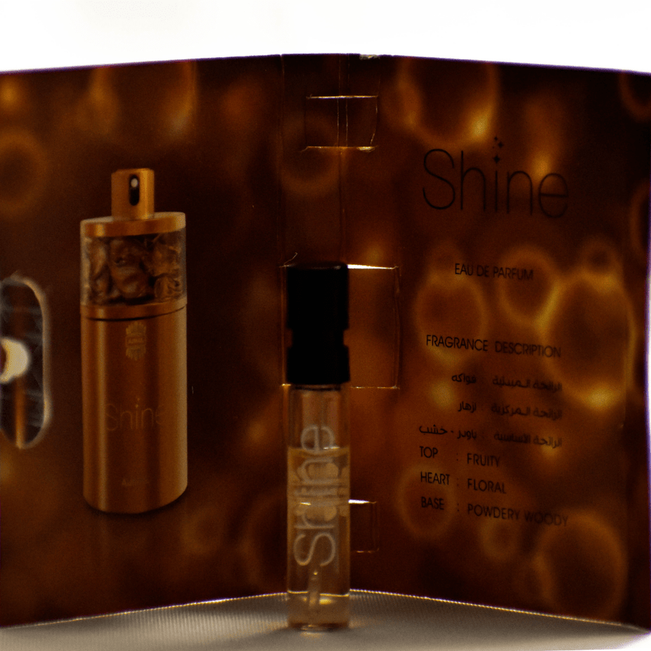 Ajmal 1 Shine EDP sample for women, 1ml perfume vial, clear glass bottle with white cap, showcasing the fragrance sample.