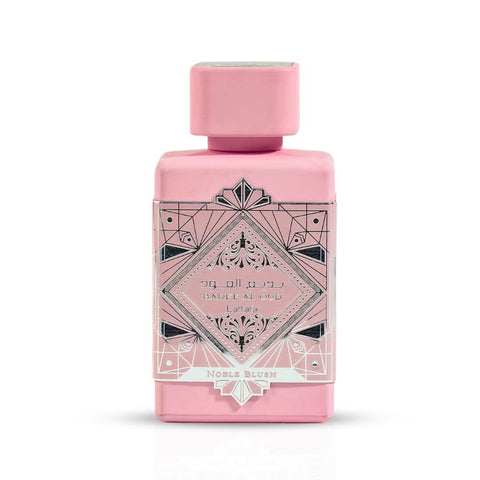 Lattafa Bade'e Al Oud Noble Blush Eau De Parfum spray in 100ml bottle, showcased with a velvet pouch in the image.