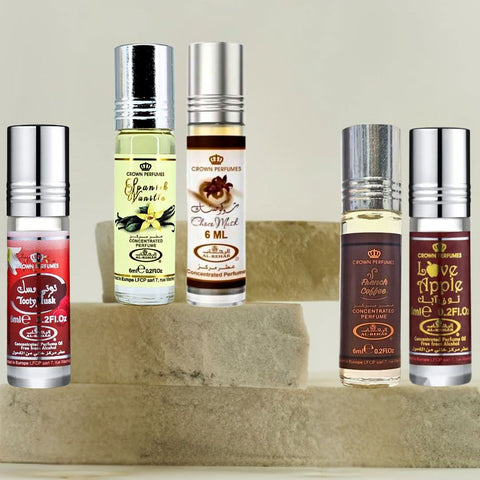 Collection of Al Rehab perfume oils including Choco Musk, Spanish Vanilla, French Coffee, Love Apple, and Tooty Musk in 6ml bottles.