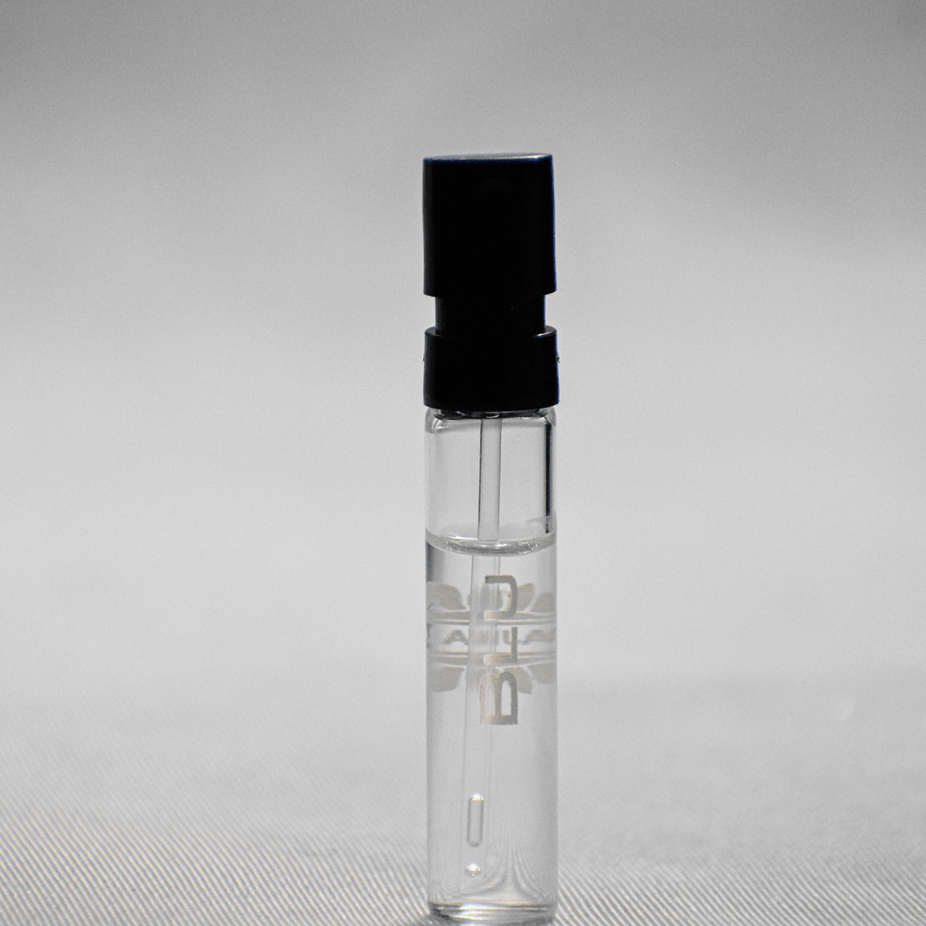 Ajmal Blu EDP sample for men, 1ML vial, featuring sleek packaging and clear scent description on the label.