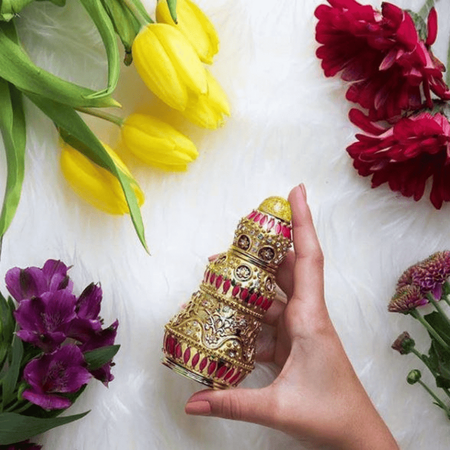 Rasasi Insherah Gold Perfume Oil 15ml bottle, concentrated fragrance with gold accents, showcasing elegant packaging and branding.