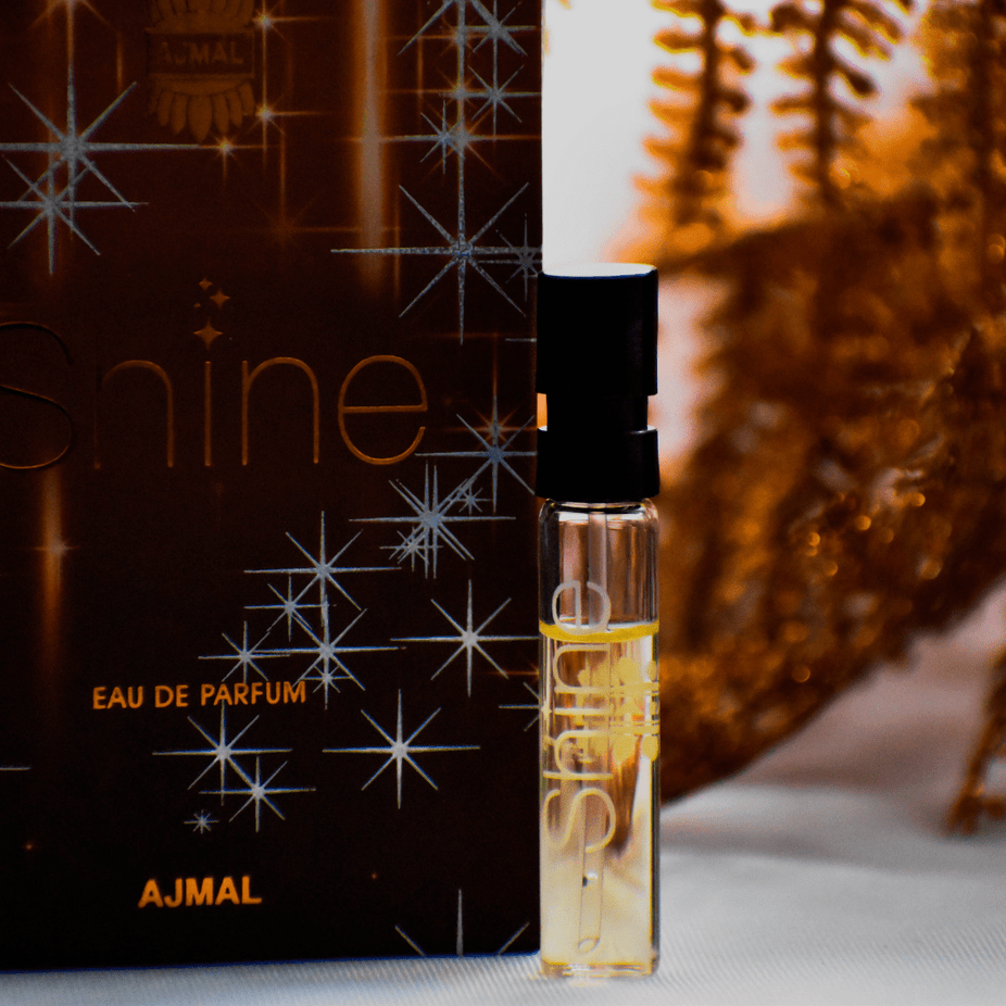 Ajmal Shine EDP sample for women, 1ml, featuring a clear vial with a white cap and the product label visible.