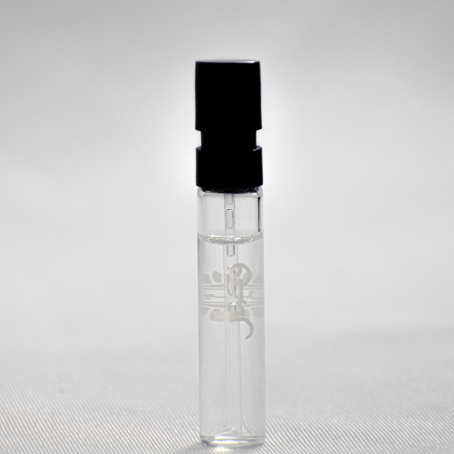 Ajmal Wisal EDP sample for women, 1ML perfume vial, small clear glass container with white cap and label, on a white background.