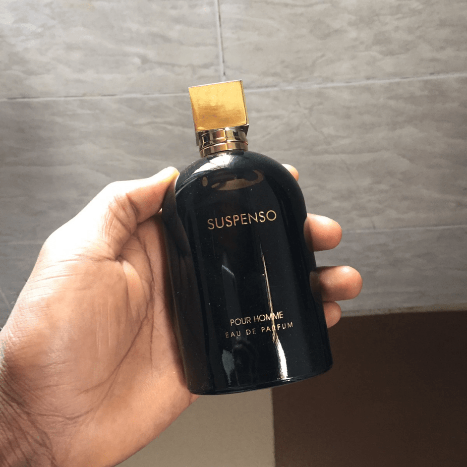 Fragrance World Suspenso Men Eau De Parfum 100ML bottle with sleek black and silver design on a neutral background.