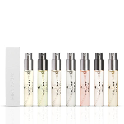 Mind Games Olfactive Fruity 7-piece discovery set with seven 7.5ml fragrance bottles, showcasing colorful packaging and variety.