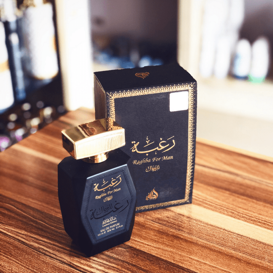 Lattafa Raghba for Men Eau de Parfum spray and deodorant, 100ml, featuring a sleek bottle with dark accents and modern design.