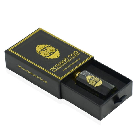 Intense Oud Jannet El Firdaus perfume oil in a 12ml bottle with a black gift box, featuring loose oil and elegant packaging.
