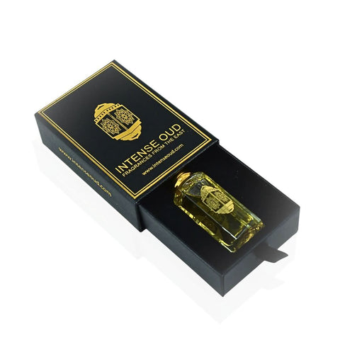 Intense Oud Attar Majmu perfume oil in a 12ml bottle with black gift box, featuring a clear glass bottle and black cap.