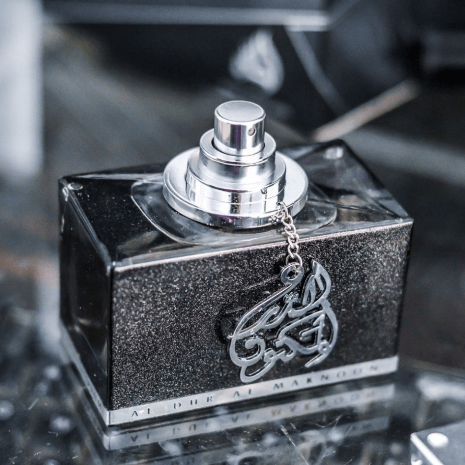Lattafa Al Dur Al Maknoon Silver for Men EDP 100ML bottle in a velvet pouch, showcasing sleek packaging and elegant design.