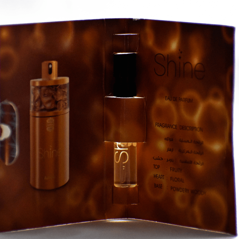 Ajmal Shine EDP sample for women, 1ml, featuring a clear vial with a white cap and product label.