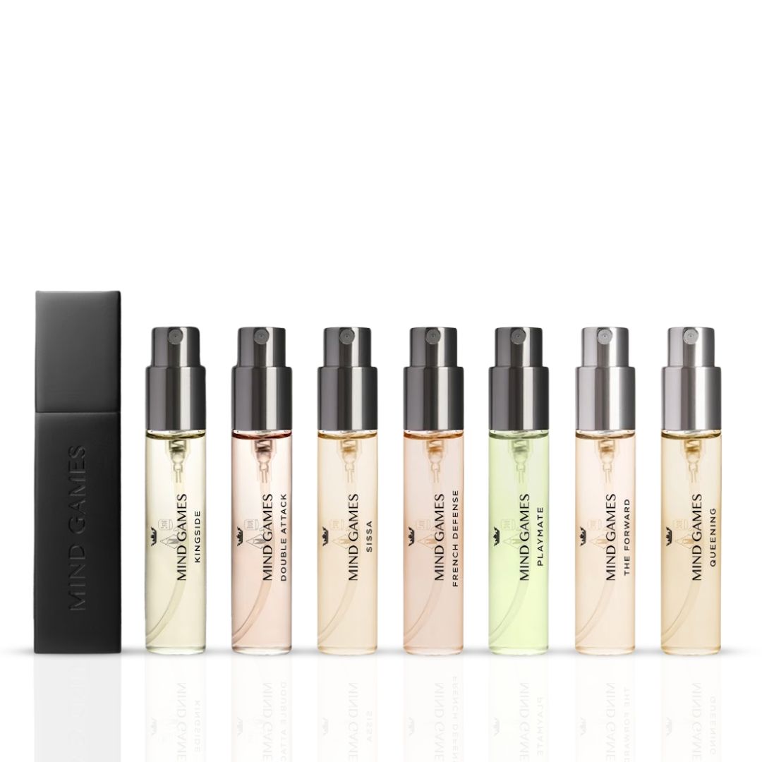 Mind Games Olfactive Amber 7-piece discovery set with seven 7.5ml fragrance bottles arranged in a display.