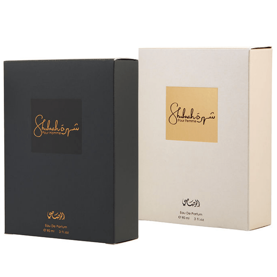 Rasasi Shuhrah men and women EDP bundle, 90ml bottles, showcasing elegant perfume packaging and branding.
