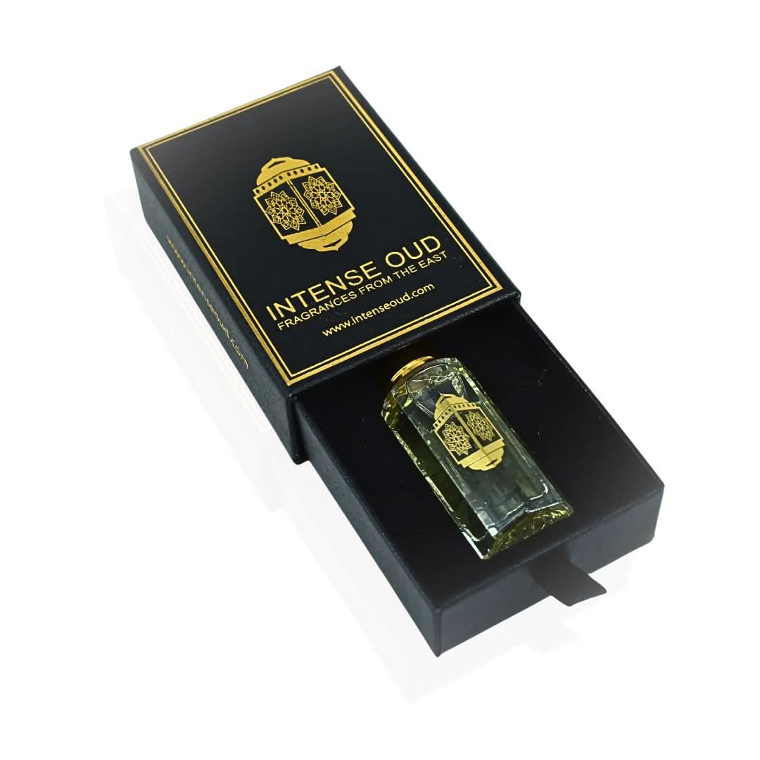 Intense Oud Musk Al Bakhoor perfume oil 12ml in a clear glass bottle, displayed with a black gift box, highlighting its luxurious packaging.