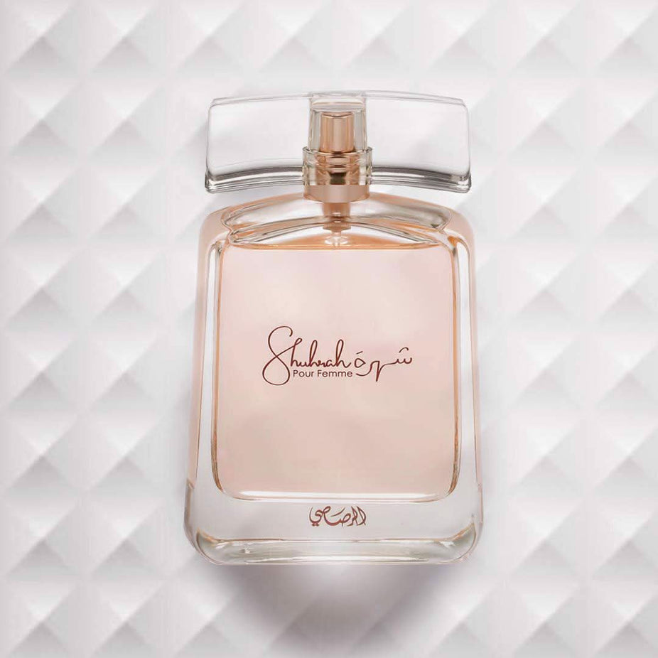 Rasasi Shuhrah for Women EDP 90ml perfume in a velvet pouch, showcasing the elegant packaging and luxurious design.