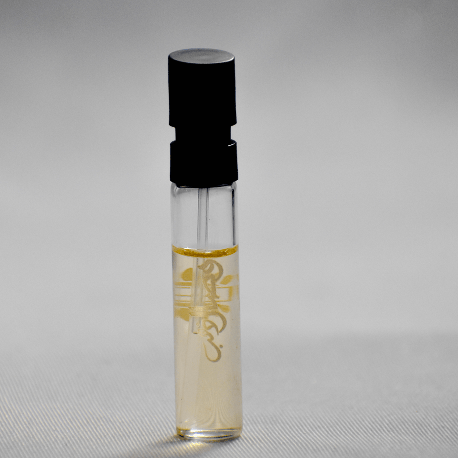 Ajmal Wisal Dhahab EDP sample bottle, unisex fragrance, 1ML, clear glass container with silver cap and fragrance label.