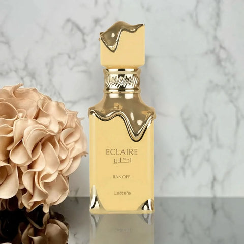 Lattafa Eclaire Banoffi Eau de Parfum spray 100ml in a velvet pouch, featuring elegant bottle design and fragrance details