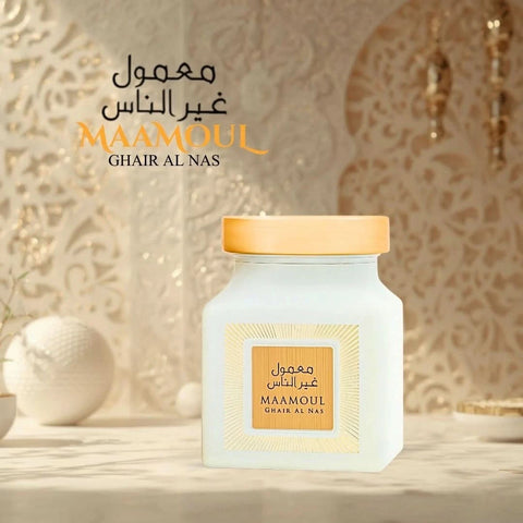 Rasasi Maamoul Ghair Al Nas Bakhoor 150g with aromatic burnt wood and herbal scents, in a decorative container.