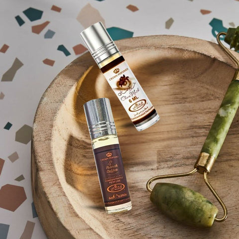 Bundle of Al Rehab Choco Musk and French Coffee perfume oils, 6ml bottles with elegant packaging and fragrance labels.