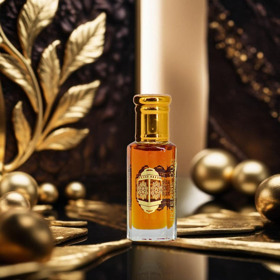 Intense Oud Nouf Perfume Oil 12ml in a black gift box, featuring a clear glass bottle with a silver cap and dark liquid perfume oil.