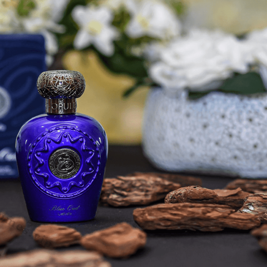 Blue Oud EDP by Lattafa, 100ML, elegant glass bottle with blue accents, showcasing the luxurious Eau De Parfum design.