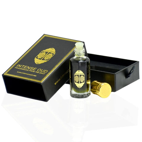 Intense Oud Jannet El Firdaus perfume oil 12ml in a black gift box, featuring a clear glass bottle with a silver cap.