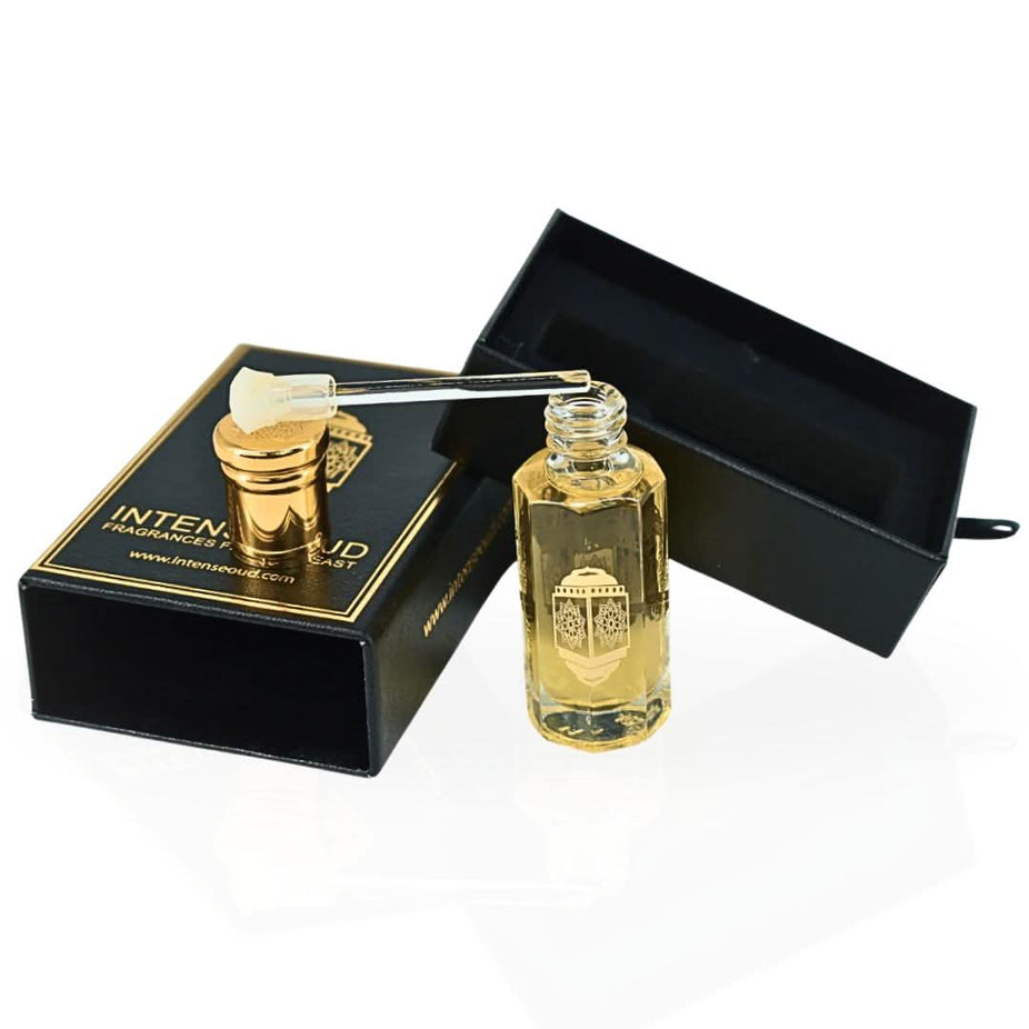 Intense Oud Touch Of Amber perfume oil in a 12ml bottle with black gift box, featuring a sleek glass container and gold accents.