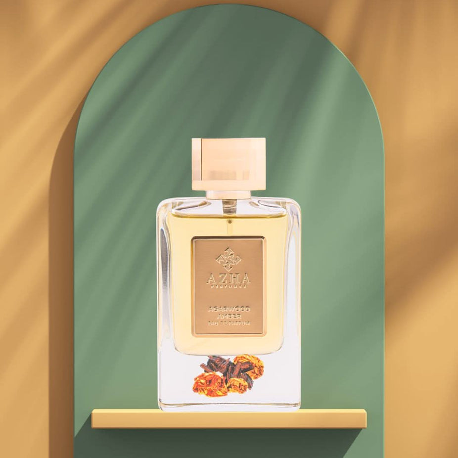 Aromatic Azha Agarwood Amber Eau de Parfum spray bottle, 100ml, with a sleek design and amber-colored liquid inside.