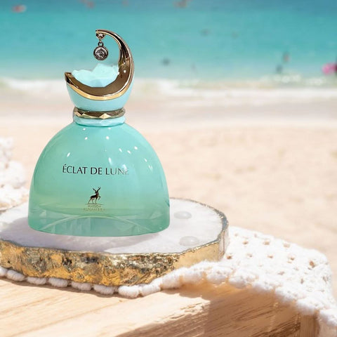 Maison Alhambra Eclat De Lune Eau de Parfum spray 100ml with velvet pouch, featuring elegant glass bottle and matching cap.