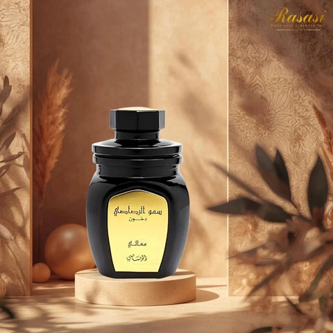Rasasi Somow Al Rasasi Ma’ali Dakhoon Bakhoor 100g with aromatic wood and resin pieces in a decorative container.