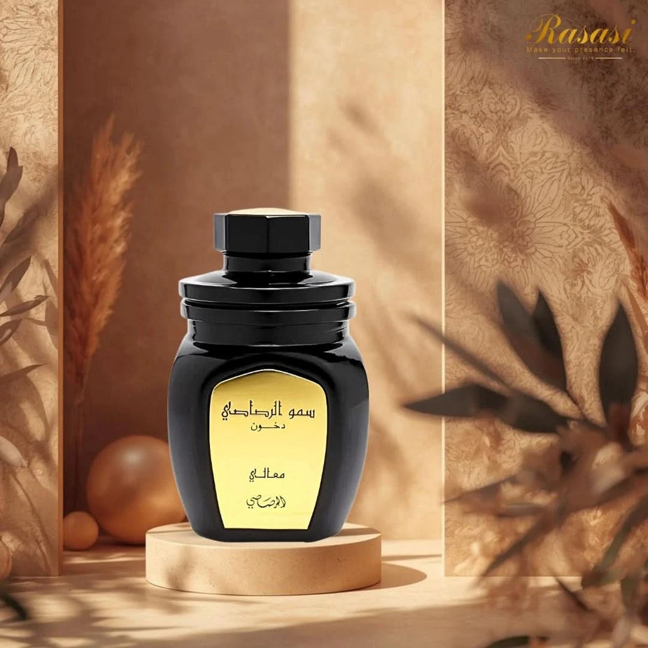 Rasasi Somow Al Rasasi Ma’ali Dakhoon Bakhoor 100g with aromatic wood and resin pieces in a decorative container.
