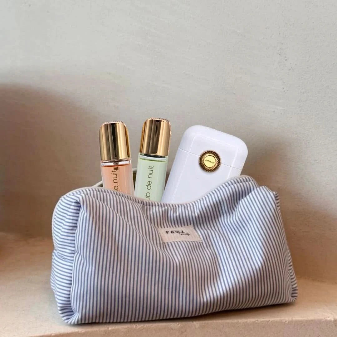 Armaf Club De Nuit Woman perfume travel set with 12ml bottles, including a compact spray and matching containers for on-the-go.