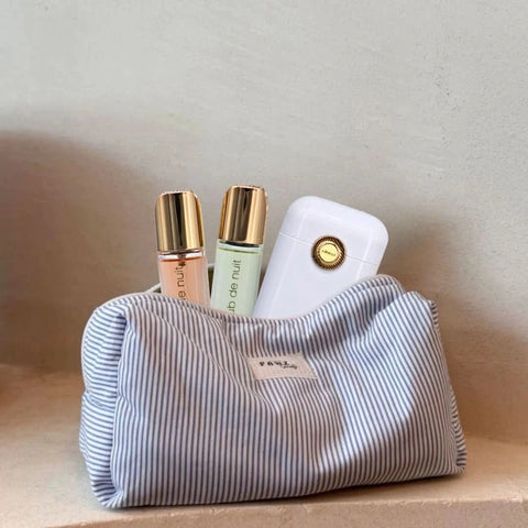 Armaf Club De Nuit Woman perfume travel set with 12ml bottles, including a compact spray and matching containers for on-the-go.