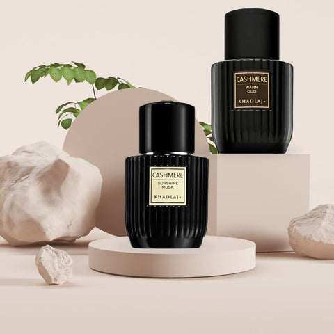 Khadlaj bundle of two 100ml Eau de Parfum sprays featuring Cashmere Sunshine Musk and Warm Oud scents, with elegant bottle designs.