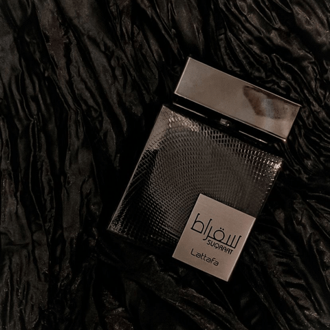 Lattafa Suqraat Eau de Parfum spray 100ml with elegant velvet pouch, featuring a decorative perfume bottle and cap.
