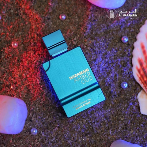 Amber Oud Aqua Dubai Eau de Parfum spray by Al Haramain, 75ml bottle with velvet pouch, featuring amber and oud notes.