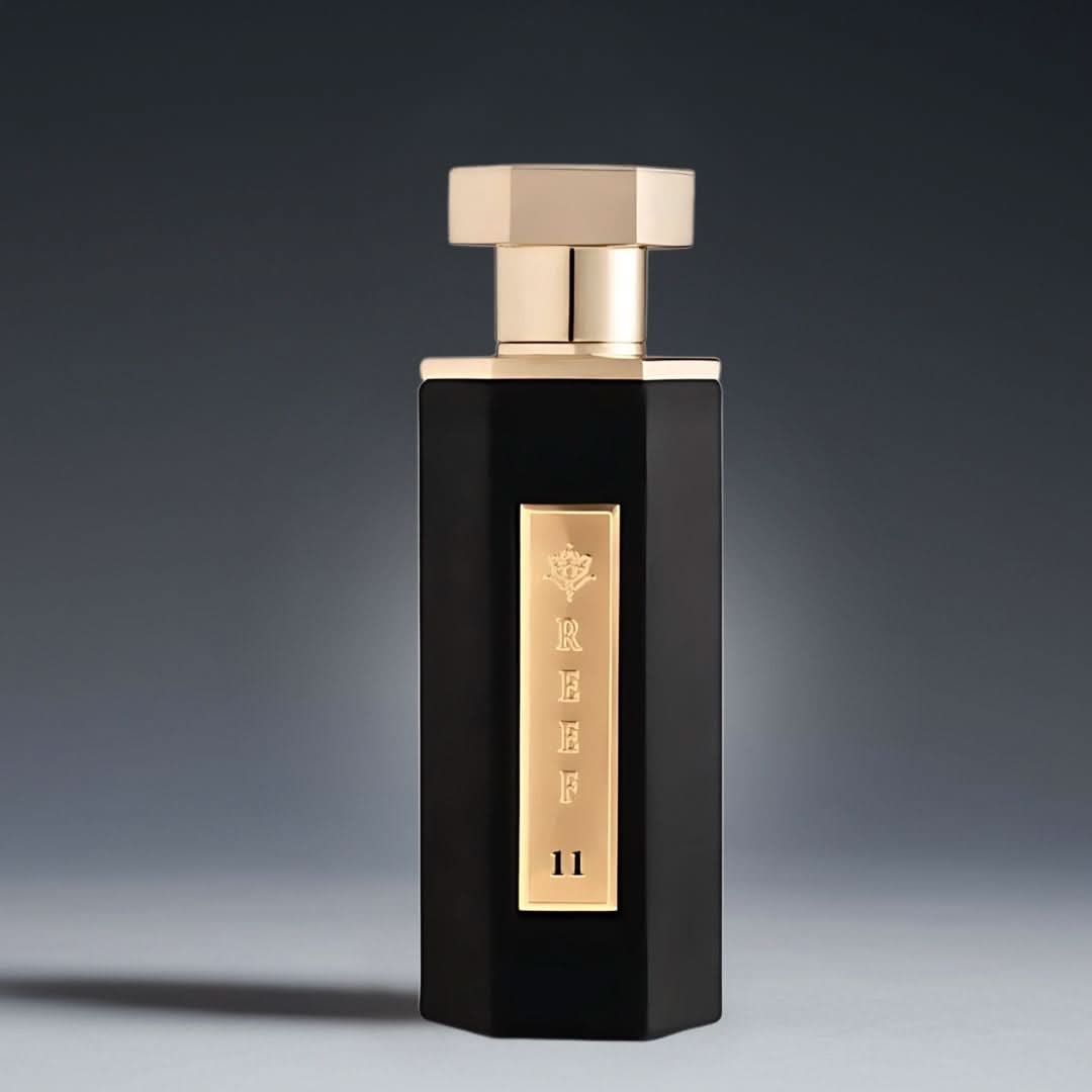 Reef 11 Eau de Parfum Spray 100ml bottle with velvet pouch, featuring sleek glass design and elegant fragrance branding.