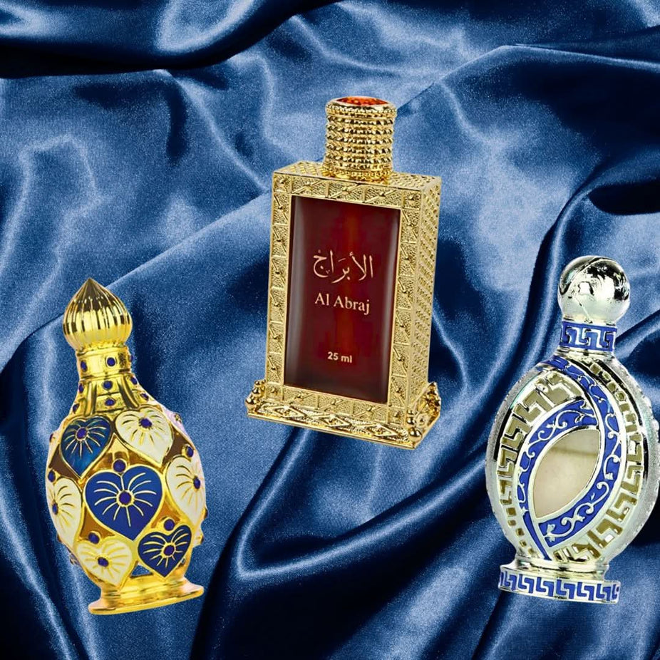 Hamidi Al Abraj Jawahir Iqra perfume oils collection, featuring six elegant perfume bottles with intricate designs and labels.
