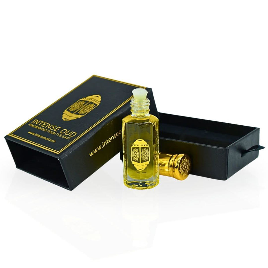 Intense Oud Bloom Perfume Oil 12ml in black gift box, featuring a clear glass bottle with a silver cap and floral accents.
