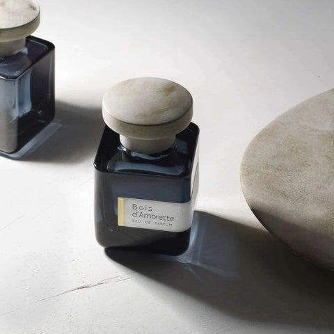 Bois d'Ambrette Eau de Parfum spray by Atelier Materi, 100ml, featuring a sleek glass bottle with elegant label and cap.