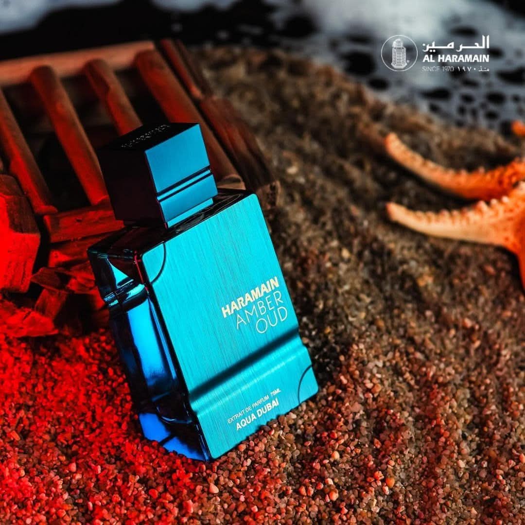 Amber Oud Aqua Dubai Eau De Parfum spray by Al Haramain, 75ml bottle in a velvet pouch, featuring amber and oud notes.
